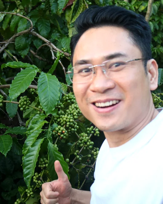 Real photograph supplied by client, showing a visitor in a coffee-growing area